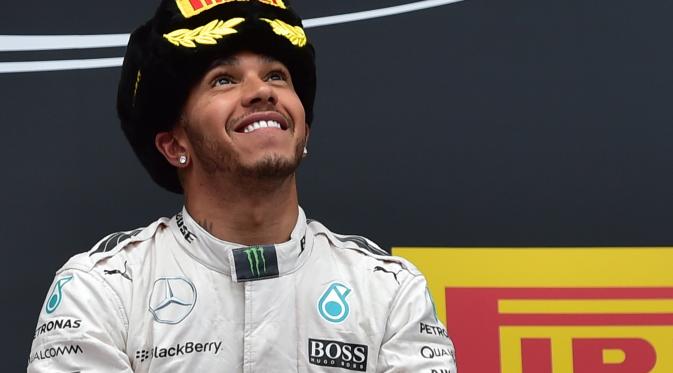 Pebalap Mercedes Lewis Hamilton merayakan kemenangan dalam ajang Formuma 1 GP Rusia di Sochi Autodrom, Minggu (11/10/2015). (Liputan6.com/ANDREJ ISAKOVIC / AFP)