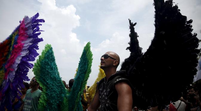 Peserta mengenakan kostum unik selama mengikuti parade di pantai Copacabana di Rio de Janeiro, Brasil, Minggu (15/11/2015). Ribuan orang berpartisipasi dalam parade kebanggan bagi orang gay dan lesbian di Brasil. (REUTERS/Pilar Olivares)