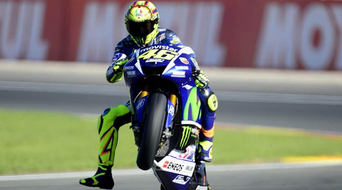 Pebalap Moviestar Yamaha, Valentino Rossi, melakukan jumping wheelie saat latihan jelang GP Valencia di Sirkuit Ricardo Tormo, Spanyol. (AFP/Jose Jordan)