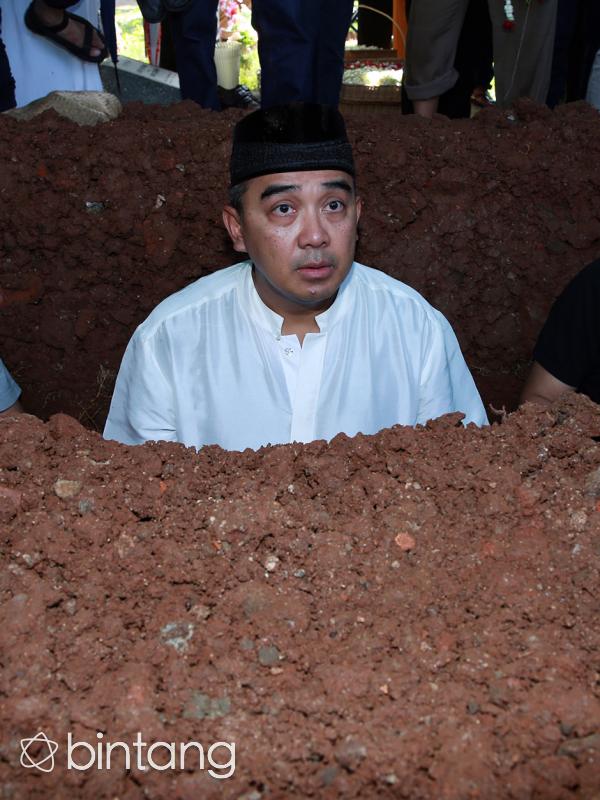 Jenazah Kiki dimakamkan  di TPU Tanah Kusir, Jakarta Selatan pada Senin (21/12/2015). Farhan sendiri menyambut jenazah putranya tersebut di liang lahat. Usai meletakkan jenazah, ia pun segera mengumandangkan azan dan iqomah. (Deki Prayoga/Bintang.com)