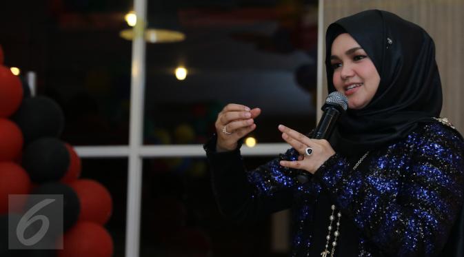 Diva asal Malaysia, Siti Nurhaliza saat merayakan ulang tahunnya ke-37 bersama para penggemarnya, Sitizoners, di restoran cepat saji di kawasan Kemang, Jakarta, Minggu (10/1). Siti Nurhaliza berulang tahun pada 11 Januari. (Liputan6.com/Herman Zakharia)