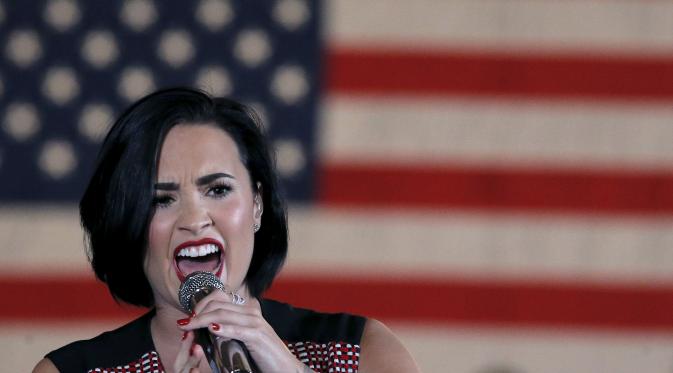 Penyanyi Demi Lovato menyanyikan lagu saat tampil di kampanye calon presiden AS dari Partai Demokrat Hillary Clinton di Iowa City, USA, (21/1). Hillary menjadi satu-satunya perempuan yang mencalonkan diri menjadi Presiden AS. (REUTERS/Jim Muda)