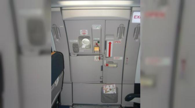 Seorang penumpang membuka pintu pesawat setelah mendarat untuk hiburan semata. (News.com.au)