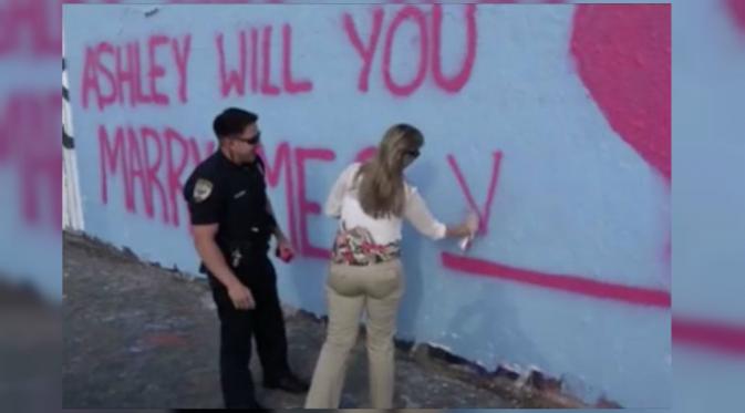 Setelah melamar, petugas meminta wanita yang kini menjadi calon istrinya untuk menulis jawaban pada tembok. (mirror.co.uk)