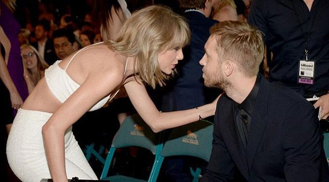 Usai menonton konser Calvin Harris, Taylor Swift langsung memberinya ciuman manis. (Liputan6.com)