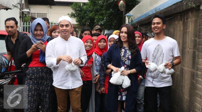 Vokalis Band Geisha Momo membagikan takjil ke pengendara yang melintas di kawasan Perdatam, Jakarta, Rabu (22/6). Memperingati bulan Ramadan Band Geisha dan Fansnya 