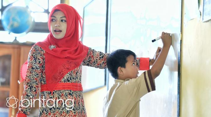 Rizma Uldiandari sedang melakukan kegiatan belajar mengajar di SD tempat ia mengajar. (Bintang.com/Adrian Putra)