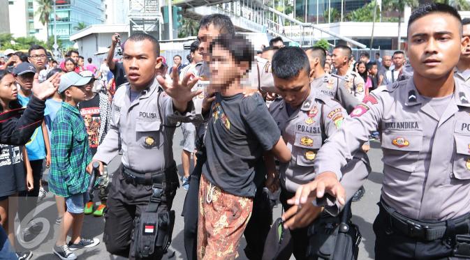 Polisi mengamankan sejumlah remaja saat Car Free Day di Jakarta, Minggu (2/10). Setidaknya empat remaja diamankan petugas karena melakukan tindakan penodongan dan pencopetan. (Liputan6.com/Angga Yuniar)