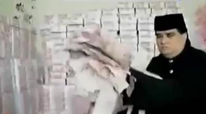 Dalam foto kliping berita tertanggal 24 Februari, Dahlan Iskan terlihat menyematkan jas ke Taat Pribadi.