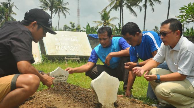 Staf pelatih Arema dan Ruddy Widodo (Manajer Umum Arema Cronus) berziarah ke makam mantan arsitek Arema, Suharno, pada Senin (31/10/2016). (Bola.com/Iwan Setiawan)