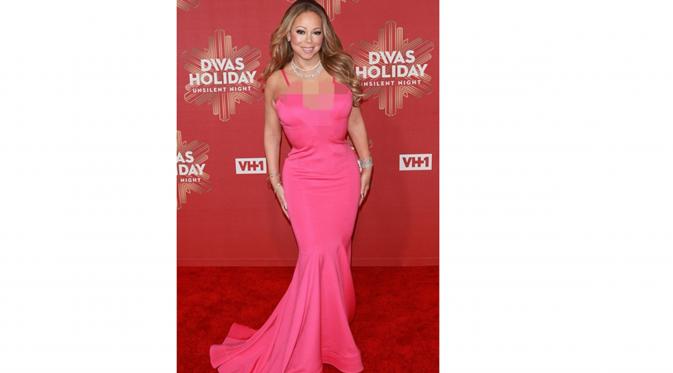 Mariah Carey dengan gaun pink asimetris yang menunjukkan belaham dadanya di red carpet di New York, Amerika Serikat, 2 Desember 2016. (Dailymail)