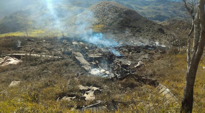 Puing-puing pesawat Hercules TNI AU yang jatuh di kawasan Wamena, Papua, Minggu (18/12). Sebanyak 12 kru dan 1 penumpang pesawat yang dalam sebuah misi perjalanan dari Timika ke Wamena itu dipastikan tewas. (HANDOUT/SEARCH AND RESCUE TEAM/AFP)