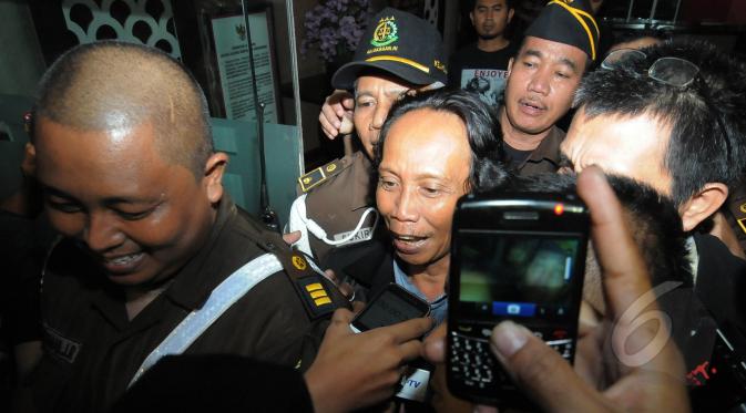 Ekpresi Mandra saat keluar dari gedung Kejaksaan Agung menuju mobil tahanan yang telah menjemputnya, Jakarta, Jumat (6/3/2015). Mandra ditahan karena diduga terlibat kasus penggelembungan dana di TVRI tahun 2012. (Liputan6.com/Herman Zakharia)