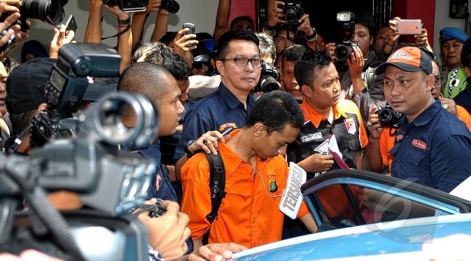 Prio Santoso (24) tersangka pembunuh Deudeuh Alfisyahrin masuk kedalam taksi saat rekonstruksi kejahatan di Tebet, Jakarta (6/5/2015). Rekonstruksi berlangsung tertutup dan diperagakan langsung oleh pelaku pembunuhan. (Liputan6.com/Yoppy Renato)