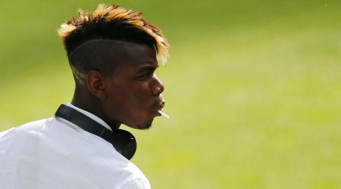 Gelandang Juventus, Paul Pogba terlihat menggigit gagang permen saat menunggu konferensi pers di Stadion Santiago Bernabeu, Spanyol (12/5/2015). Juventus akan menantang Real Madrid di leg kedua semifinal Liga Champions.  (Reuters/Sergio Perez)