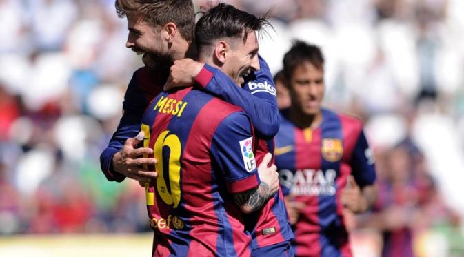 Lionel Messi dan Gerard Pique (CRISTINA QUICLER / AFP)