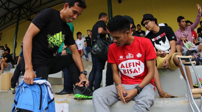 Bima Sakti menunjukkan bekas cedera parah pada engkelnya kepada Alfin Tuasalamony. (Bola.com/Arief Bagus)