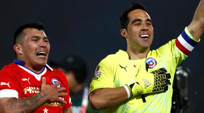 Gary Medel dan Claudio Bravo merayakan kemenangan negaranya usai mengalahkan Argentina di Final Copa America 2015 di Stadion Nasional, Chili, (4/7/2015). Chili menang lewat adu penalti atas Argentina dengan skor 4-1. (REUTERS/Henry Romero)