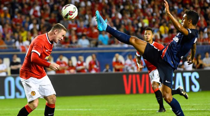 Penyerang MU, Wayne Rooney (kiri) berebut bola dengan bek PSG Marquinhos pada pertandingan International Champion Cup di stadion soldier, Chicago, AS, Kamis (30/7/2015). PSG menang dengan skor 2-0 atas Manchester United.  (Reuters/Mike diNovo)