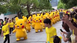 Para pejalan kaki teralihkan perhatiannya dengan barisan Pikachu, si pokemon kuning lucu.