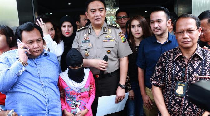 Minola Sebayang di Polda Metro Jaya bersama tersangka dan aparat kepolisian. (Wimbarsana/Bintang.com)