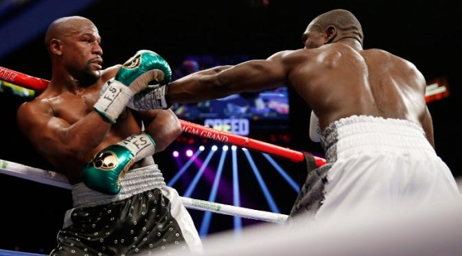 Mayweather Jr. menghindari pukulan Andre Berto (Ezra Shaw/Getty Images/AFP)